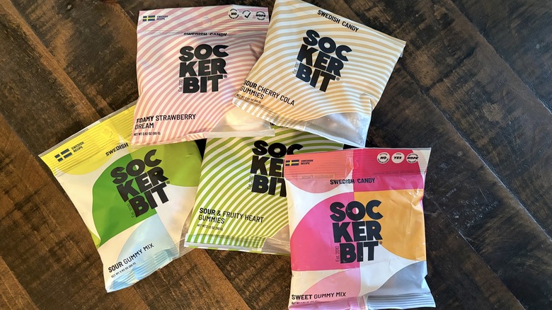 Sockerbit gummy candy in bags on wooden background.