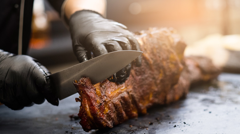 Chef cutting a rack of ribs