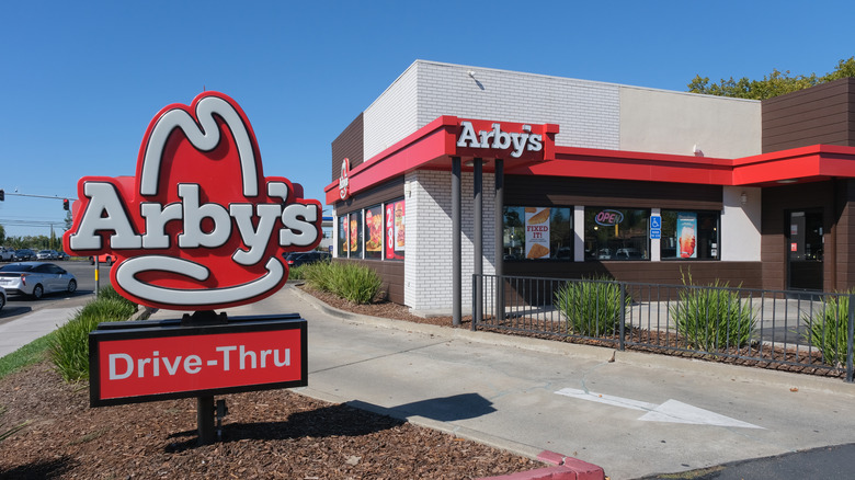 an Arby's drive through sign in front of the restaurant