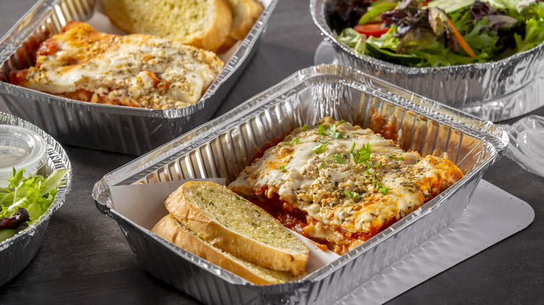 Various take out foods in disposable aluminum containers