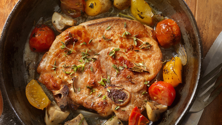 pork steak surrounded by tomatoes