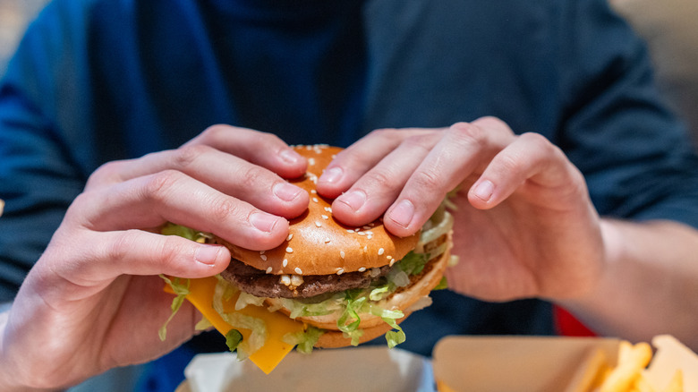 customer eating fast food hamburger in restaurant
