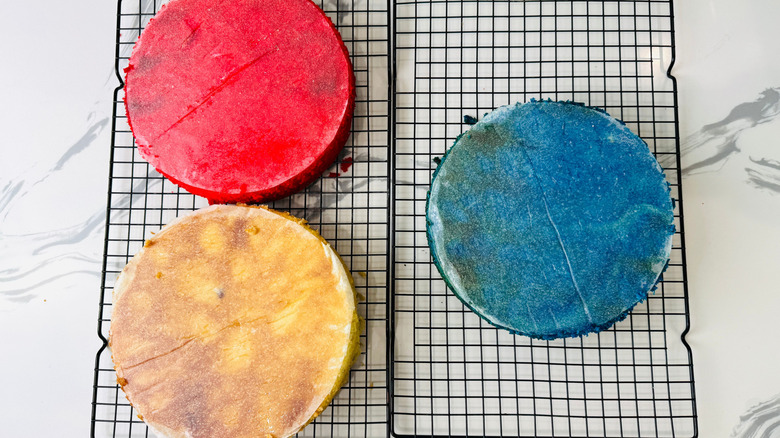 Red, white, and blue cakes on wire racks