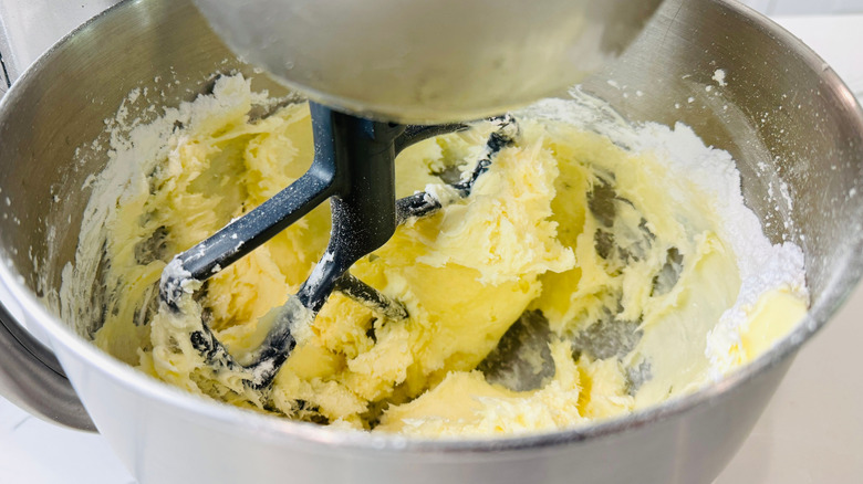 Mixing cream cheese frosting in stand mixer bowl