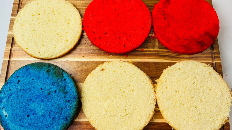 Red, white, and blue cake layers on wooden board