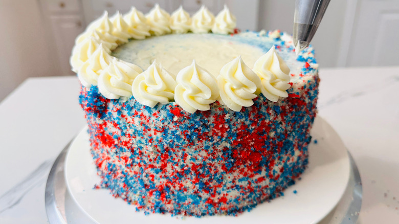 Red, white, and blue cake with frosting rosettes