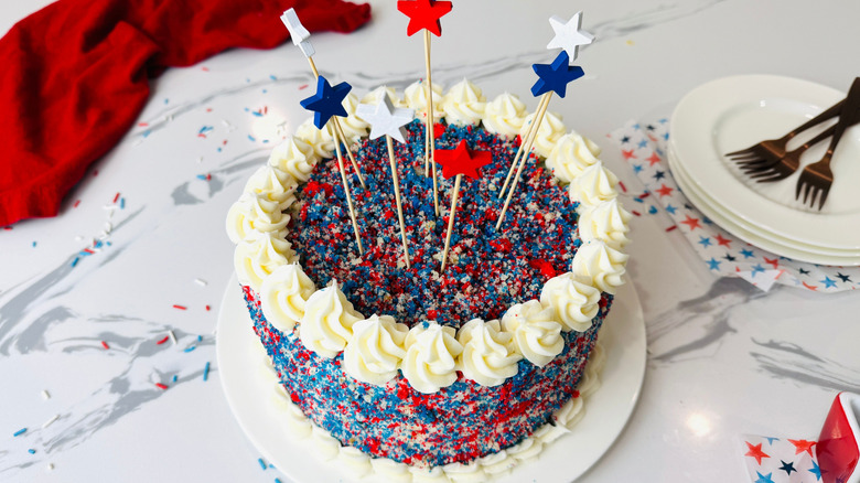 Red, white, and blue cake with decorative star toppers