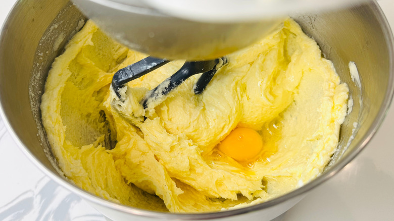 Egg in cake batter in stand mixer bowl