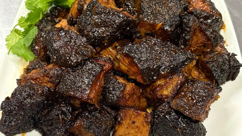 Plate of burnt ends with a garnish