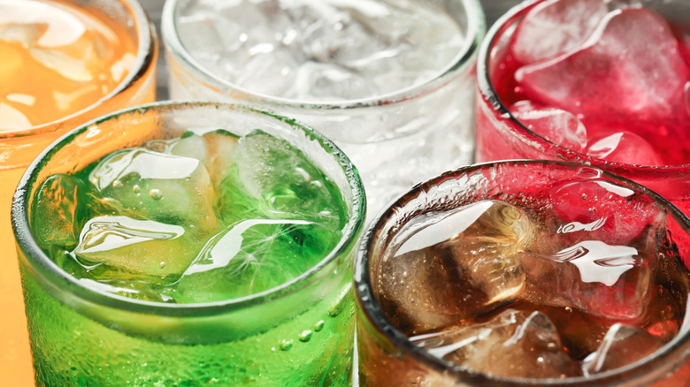 Close-up of variously colored sodas in glasses