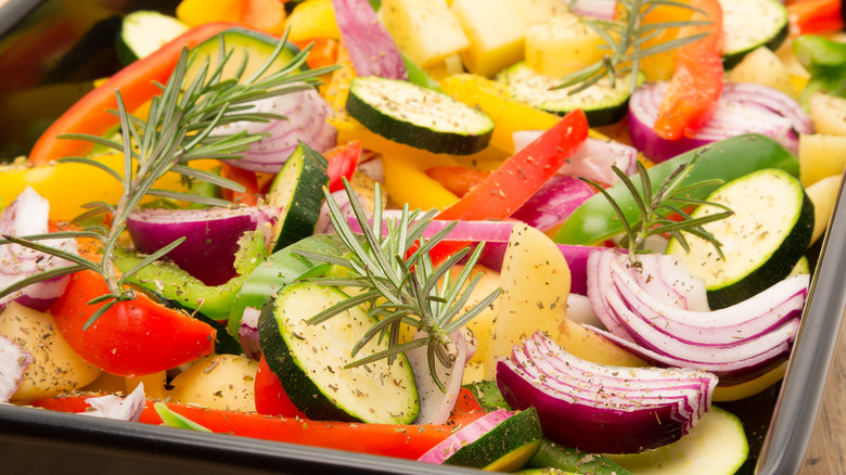 mixed raw vegetables on baking sheet