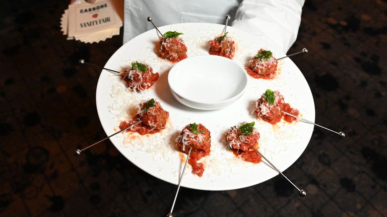 Person passing hors d'oeuvres on platter