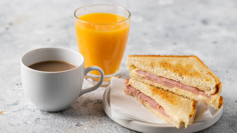 coffee and orange juice with breakfast sandwich