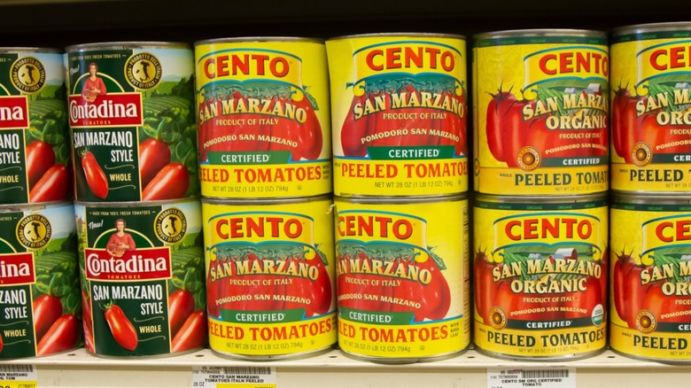 Various canned San Marzano tomatoes on a store shelf