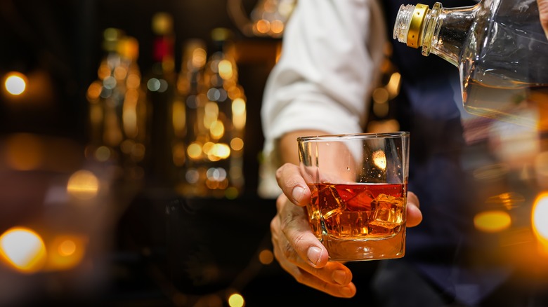 bartender pouring bourbon