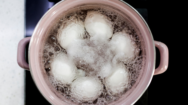 Eggs boiling in pot