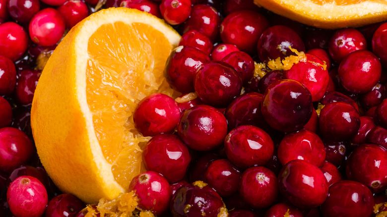 Fresh cranberries and orange wedges.
