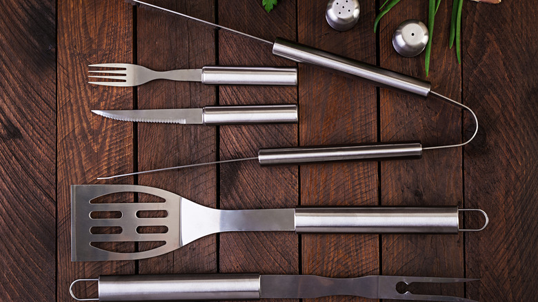 Stainless steel utensils on a wooden table