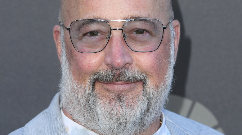 Andrew Zimmern smiling with glasses