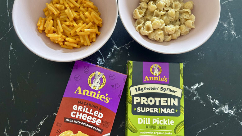 Annie's mac and cheese boxes with bowls of mac and cheese in background