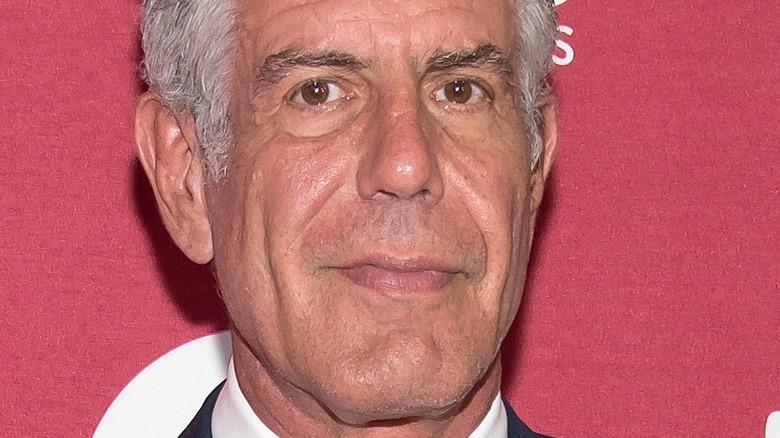 Anthony Bourdain poses at event 