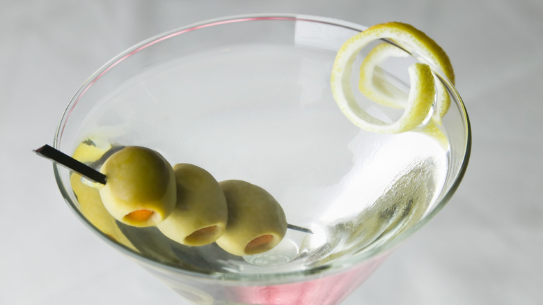 Martini with three olives and a lemon twist.