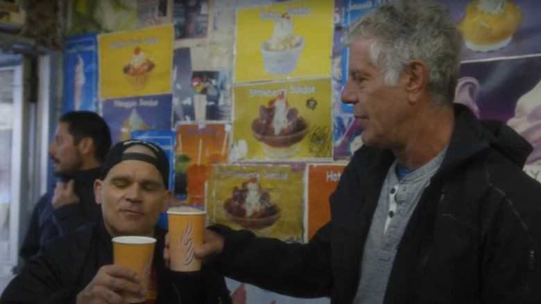 Bourdain cheersing Ray's egg creams