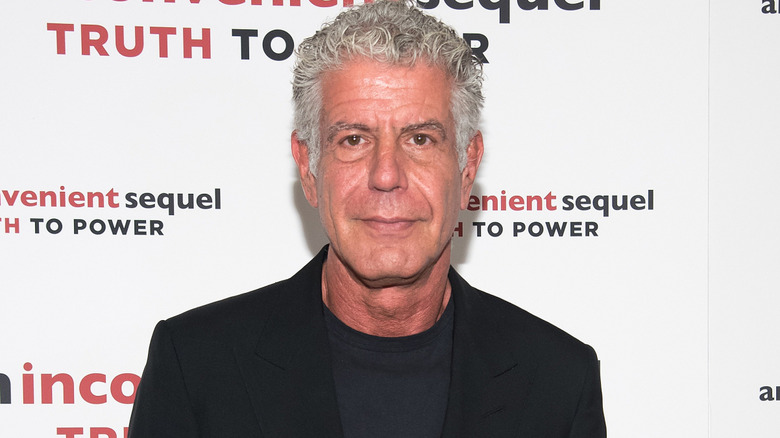 Anthony Bourdain in a black shirt and blazer