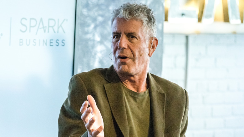 Anthony Bourdain at an event explaining something