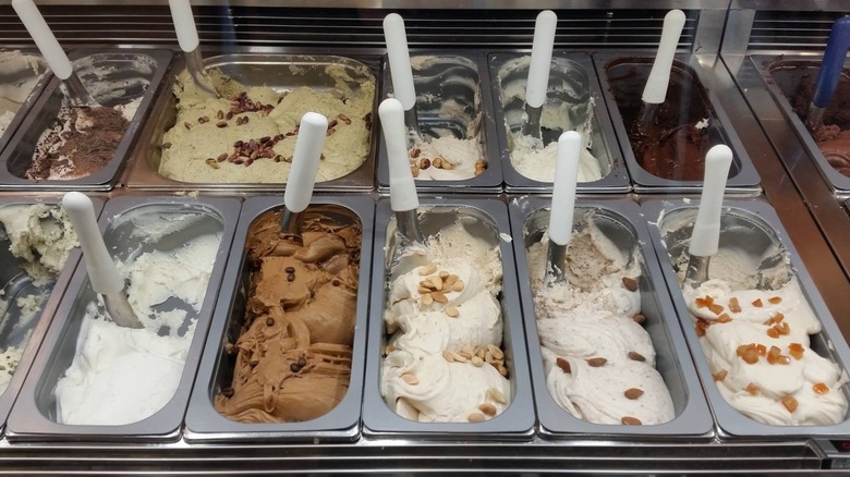 Various gelato flavors with scoops at Gelateria Dei Gracchi in Rome