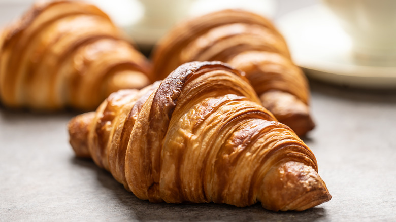 A close up of a butter croissant
