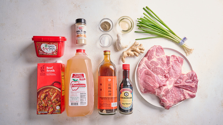 Apple cider and gochujang braised pork ingredients on a table