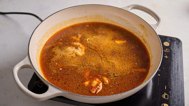 adding liquids to the braising pan