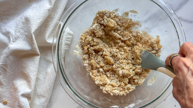 hand mixing streusel in bowl