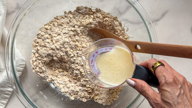 hand adding butter to bowl