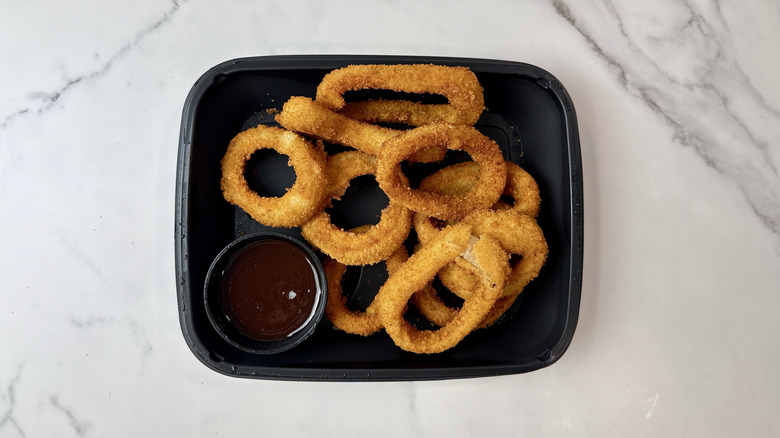 Applebee's onion rings and barbecue sauce in a to-go container