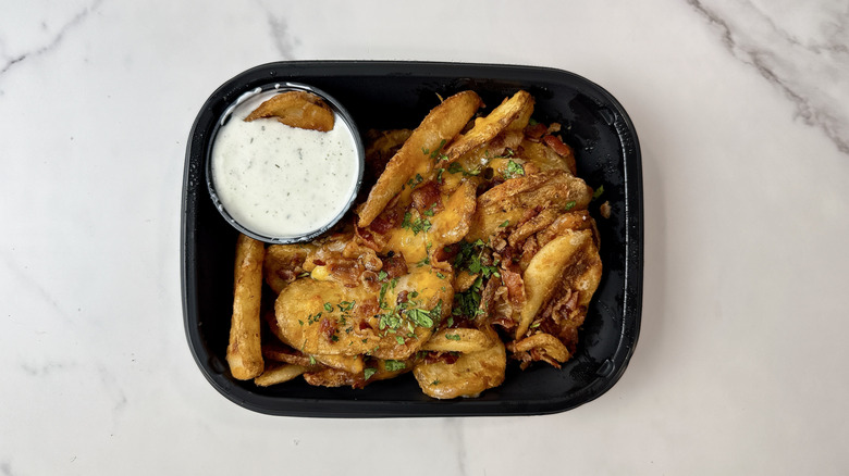 Applebee's loaded potato waves and ranch dip in a to-go container