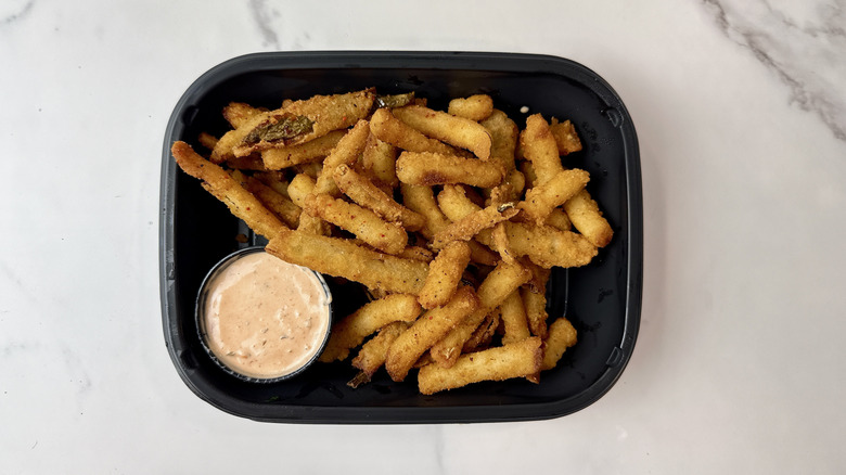 Applebee's crispy pickle fries and tartar sauce in a to-go container