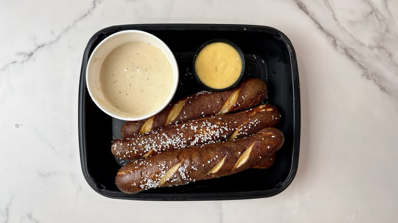 Applebee's brew pub pretzels, beer cheese, and mustard dip in a to-go container