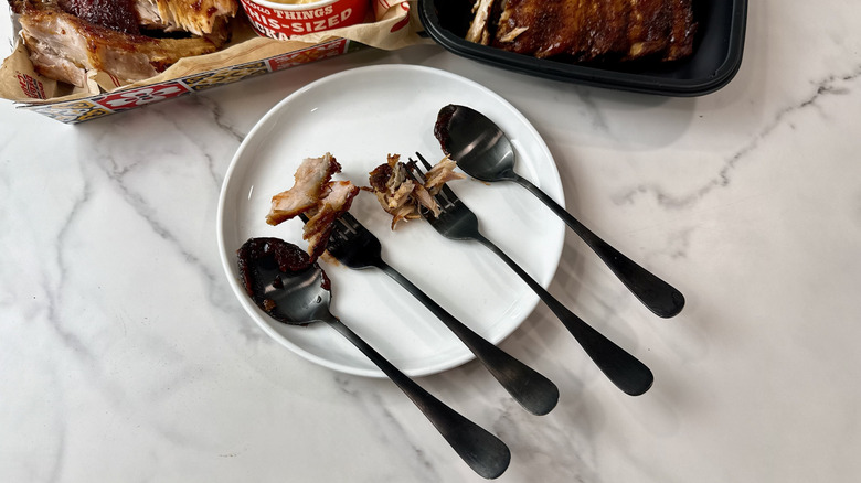 Chili's and Applebee's baby back ribs on forks and spoons on a white plate