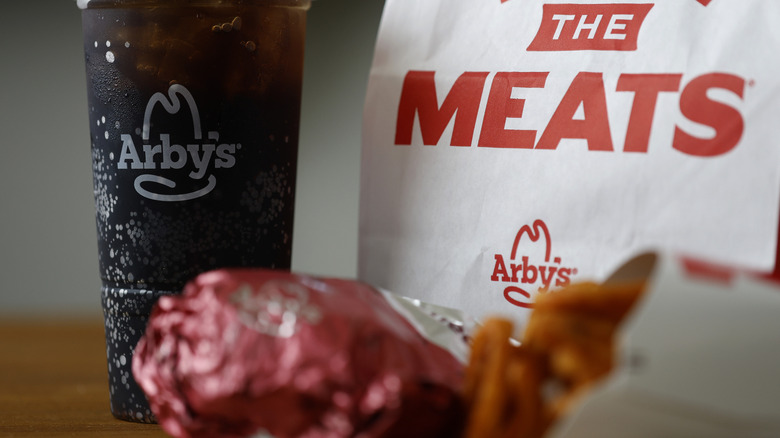 Arby's bag and drink with fries and sandwich