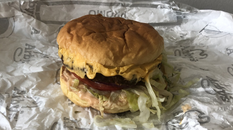Arby's deluxe burger on its wraping paper