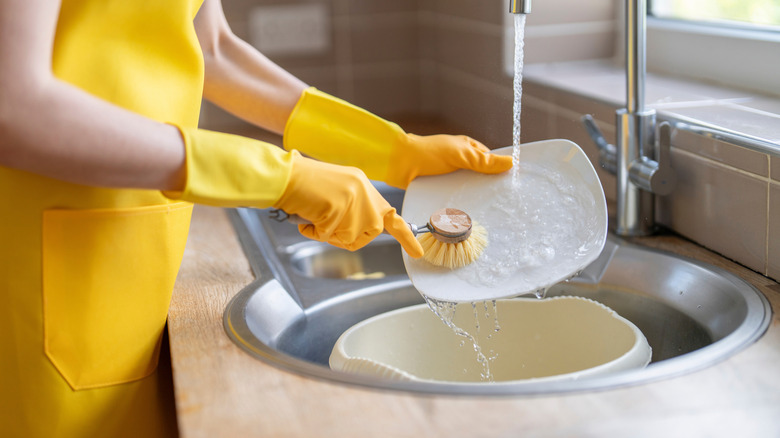 woman hand washing dishes