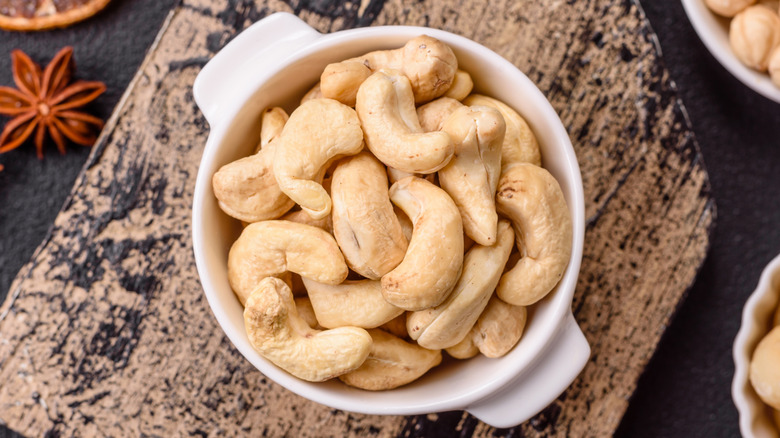 Cashew nuts in bowl on board