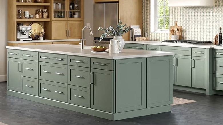Light sage green cabinets on center island in kitchen.