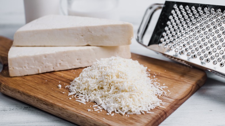 Cotija cheese grated on a cutting board