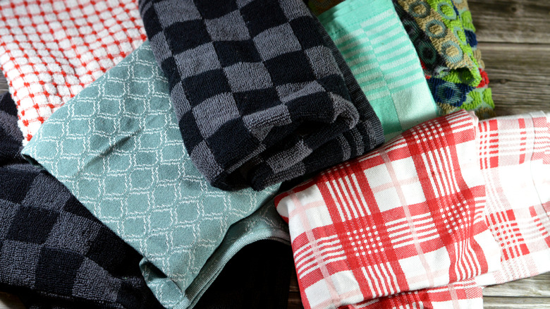 Various colorful kitchen towels, dish towels, and tea towels in a pile