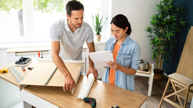 View of two people installing countertops in the kitchen