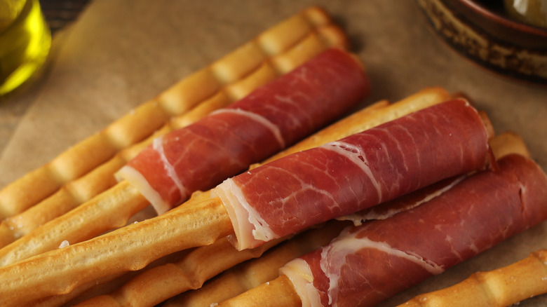 Grissini wrapped in prosciutto