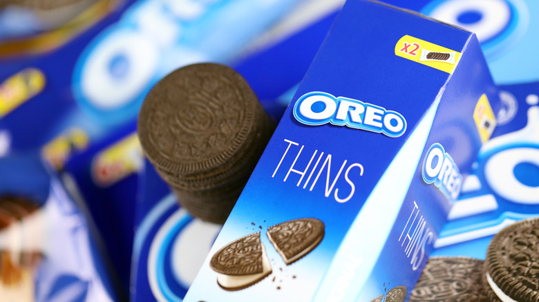 Stack of Oreo Thins next to container.